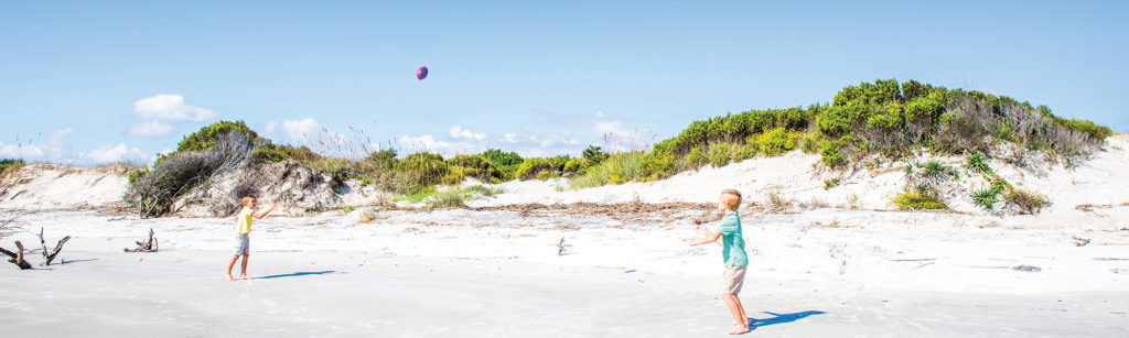 Playing football on Jekyll Island beach