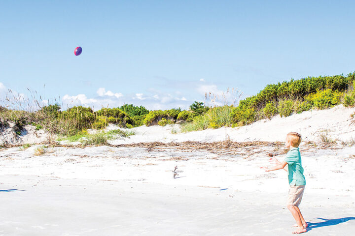 Playing football on Jekyll Island beach